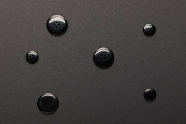 Top view of clothing buttons isolated on black — Stock Photo