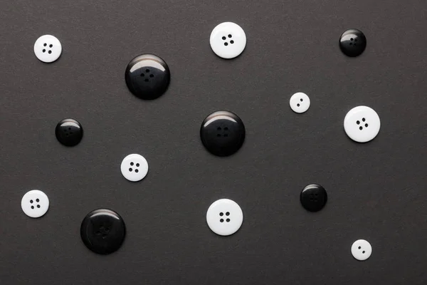 Top view of monochrome clothing buttons isolated on black — Stock Photo