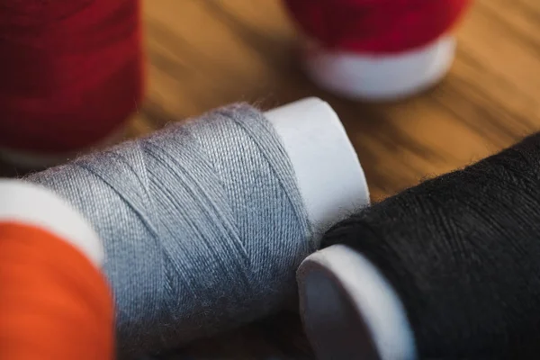 Vue rapprochée des bobines de fil de coton gris et noir — Photo de stock