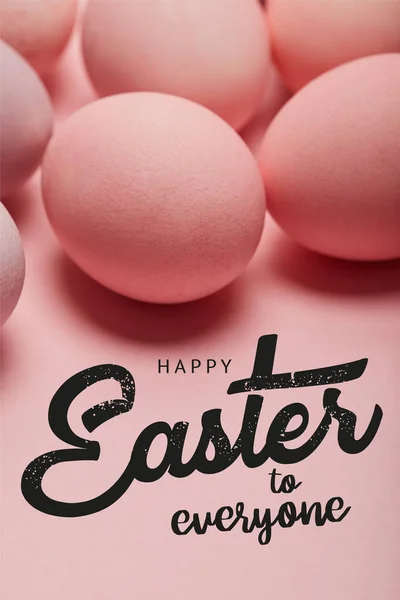 Pink painted chicken eggs with black happy Easter to everyone lettering — Stock Photo
