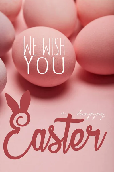 Pink painted chicken eggs with we wish you happy Easter lettering — Stock Photo