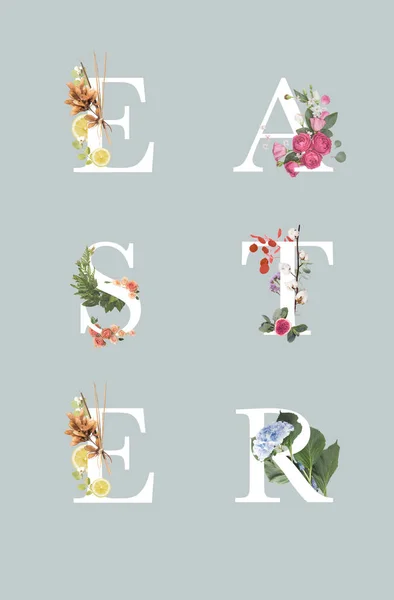 Lettrage de Pâques avec des fleurs sur des lettres blanches sur fond gris — Photo de stock