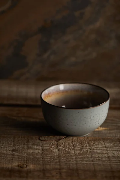 Ceramic bowl on rustic wooden table with copy space — Stock Photo