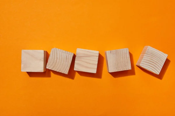 Top view of wooden blocks on orange surface — Stock Photo
