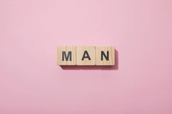 Top view of wooden cubes with letters on pink surface — Stock Photo