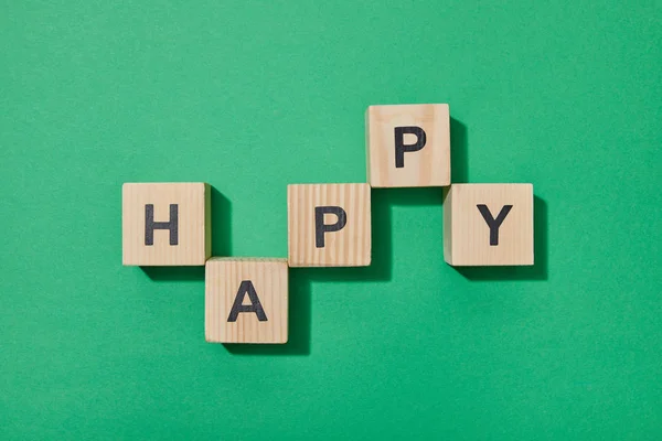 Top view of wooden blocks with letters on green surface — Stock Photo