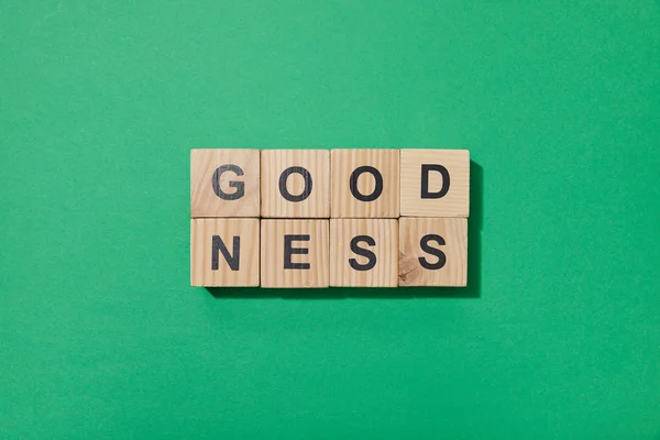 Top view of wooden blocks with letters on green surface — Stock Photo