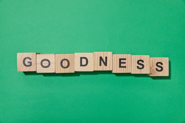 Top view of wooden blocks with letters on green surface — Stock Photo