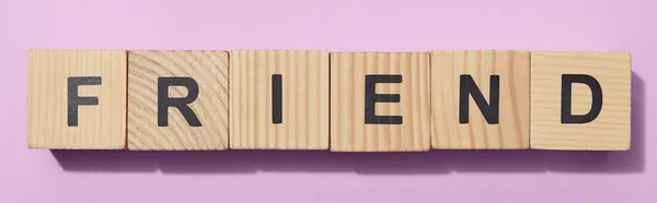 Panoramic shot of wooden cubes with letters on purple surface — Stock Photo