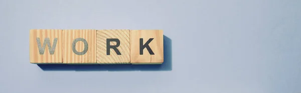 Panoramic shot of wooden cubes with letters on grey surface — Stock Photo