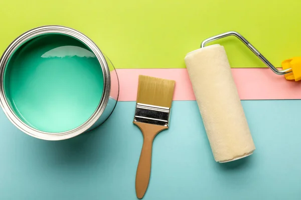 Top view of tin with green paint, paint roller and brush — Stock Photo