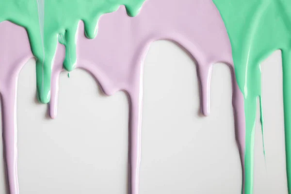 White background with purple and green flowing paints — Stock Photo