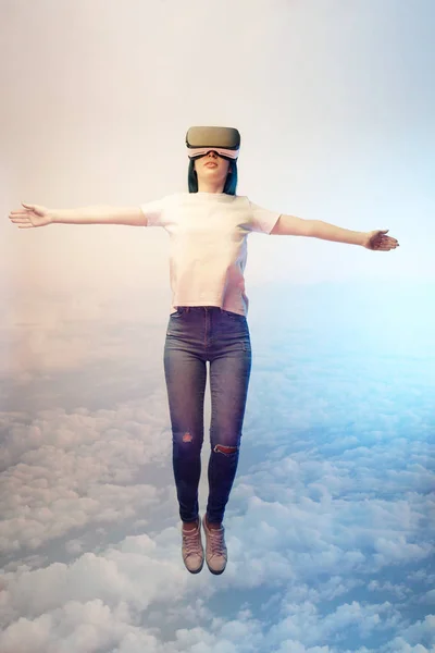 Double exposure of brunette woman levitating with outstretched hands near  clouds in sky — Stock Photo