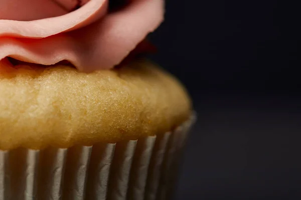 Close up view of cupcake with cream on black — Stock Photo