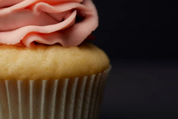 Close up view of cupcake with cream on black — Stock Photo