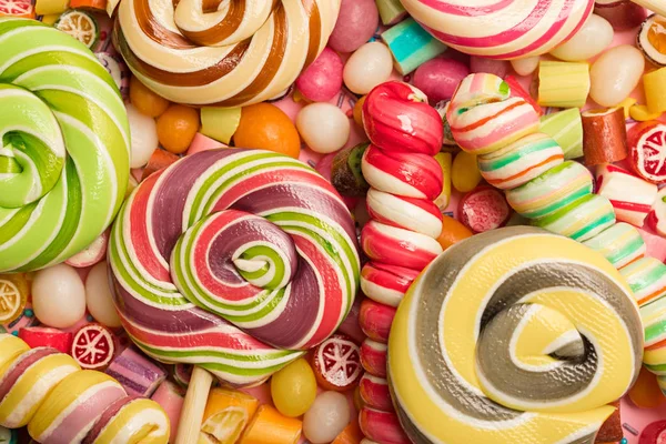 Top view of bright delicious multicolored caramel candies and lollipops — Stock Photo