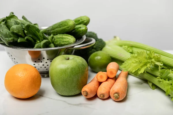 Tasty and sweet fruits near ripe and fresh vegetables on grey — Stock Photo