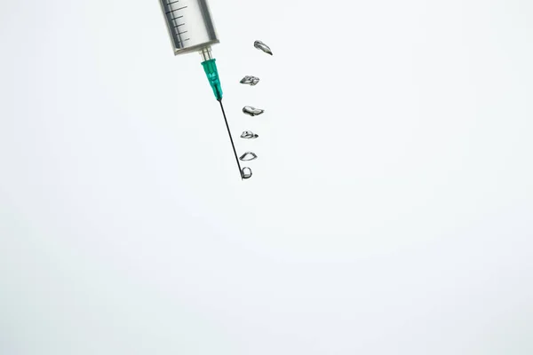 Close up of syringe with bubbles in water isolated on white — Stock Photo
