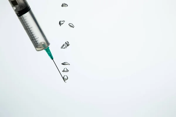 Close up of syringe with bubbles in water isolated on white with copy space — Stock Photo