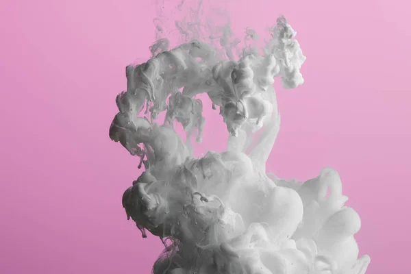 Close up view of white paint splash isolated on pink — Stock Photo