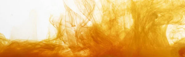 Close up view of orange watercolor paint swirls in water — Stock Photo