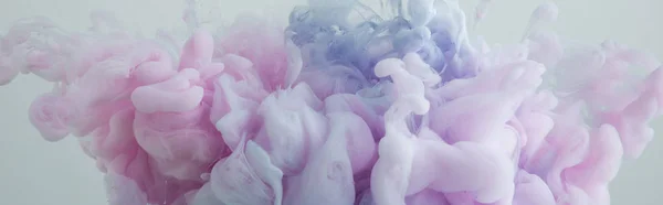 Close up view of pink and blue paint mixing isolated on grey — Stock Photo