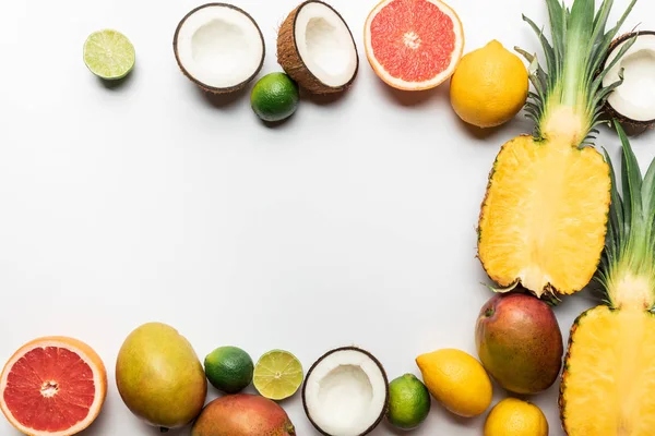 Top view of organic exotic fruits on white background with copy space — Stock Photo