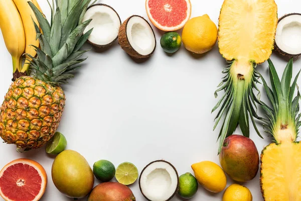 Frame made of organic exotic fruits on white background with copy space — Stock Photo