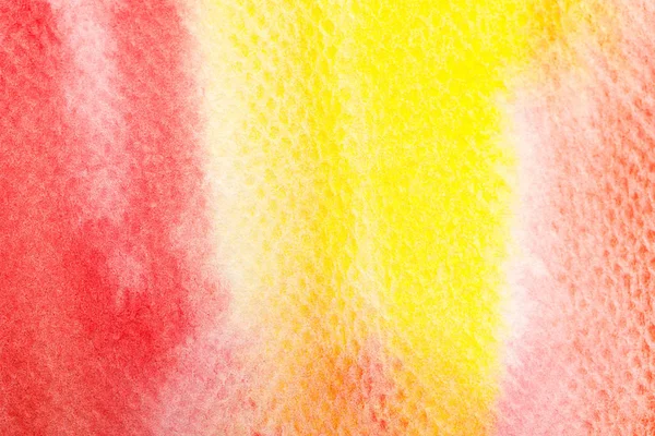 Close up view of yellow and red bright watercolor paint spills on textured background — Stock Photo