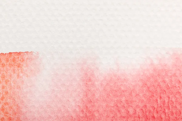 Close up view of red watercolor paint spill on white paper — Stock Photo