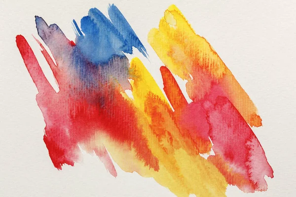 Top view of bright yellow, blue and red watercolor paint brushstrokes on white background — Stock Photo