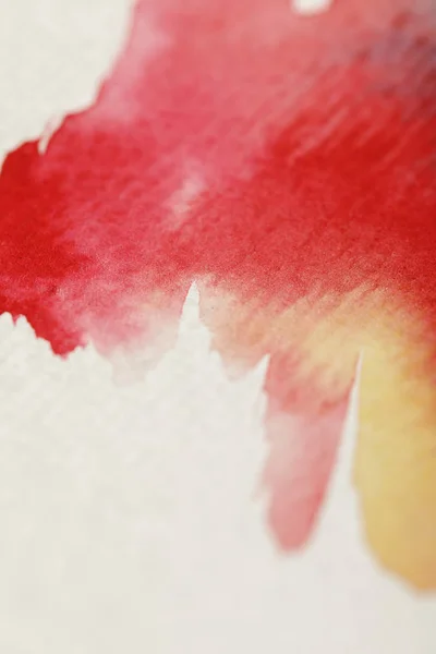 Close up view of yellow, blue and red watercolor paint spills on white background — Stock Photo