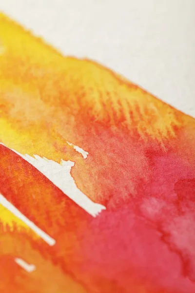 Close up view of yellow and red paint spills on white background — Stock Photo