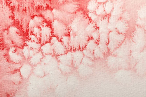 Close up view of red watercolor paint spill on white paper background — Stock Photo