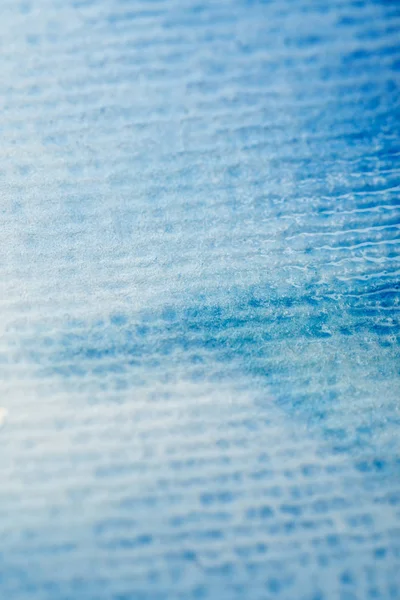 Close up view of blue watercolor paint on textured paper background — Stock Photo