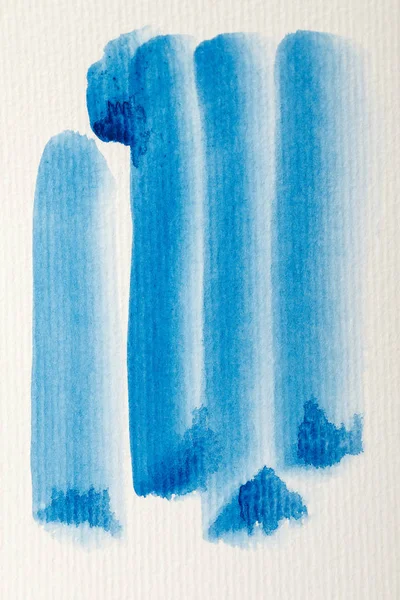 Blue watercolor paint brushstrokes on white textured background — Stock Photo