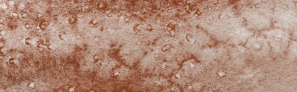 Panoramic shot of brown colorful watercolor paint spill on textured background — Stock Photo