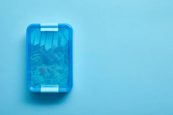 Top view of lunch box with delicious healthy meal on blue background — Stock Photo