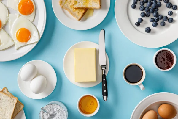 Top view of served breakfast on blue background — Stock Photo