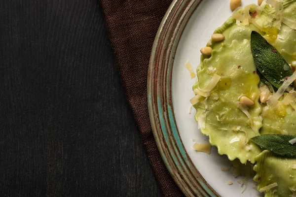 Close up view of delicious green ravioli with sage, cheese and pine nuts served in vintage plate — Stock Photo