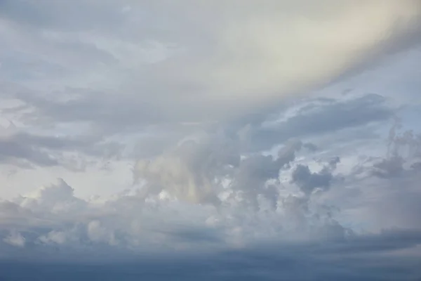 Blue clouds on white sunlight sky background — Stock Photo