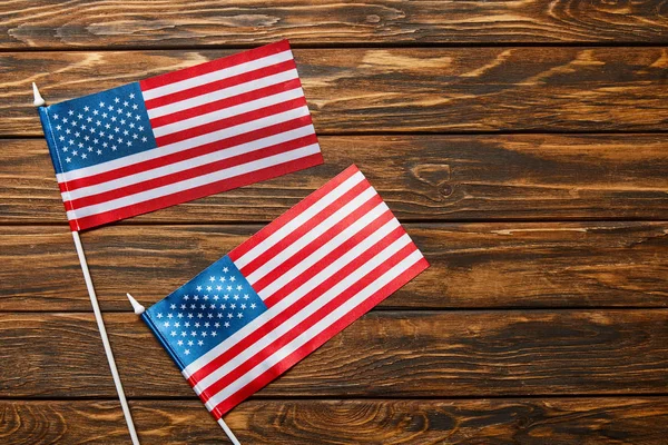 Top view of american flags on wooden surface with copy space — Stock Photo