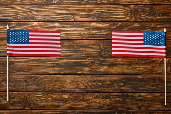 Top view of national american flags on wooden surface with copy space — Stock Photo