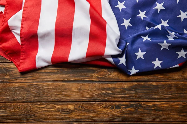 Top view of usa flag on wooden brown surface with copy space — Stock Photo