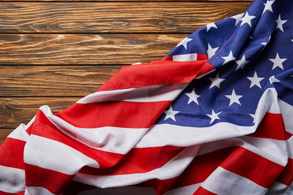Top view of usa flag on wooden textured surface with copy space — Stock Photo