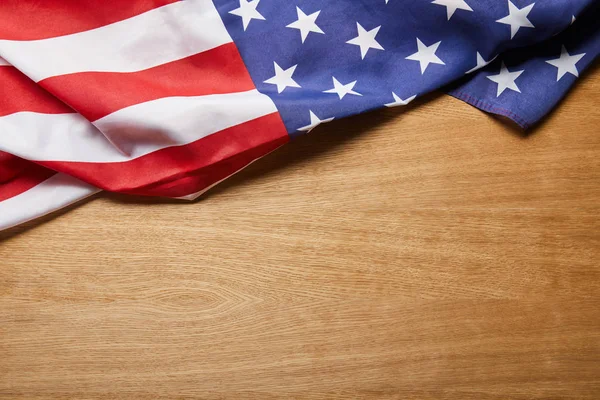 Top view of american flag on beige textured wooden surface with copy space — Stock Photo