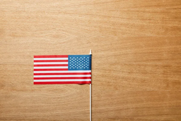 Top view of american flag on wooden table with copy space — Stock Photo