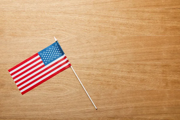 Top view of american flag on wooden textured table with copy space — Stock Photo