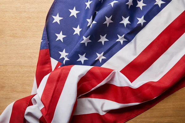 Top view of crumpled american flag on wooden surface — Stock Photo