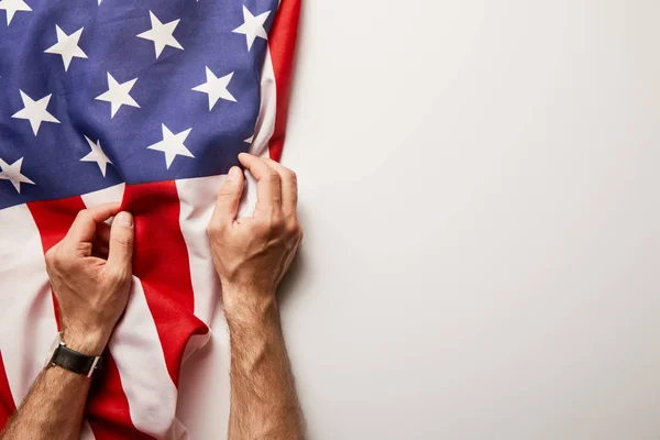 Cropped view of man holding american flag on white background with copy space — Stock Photo